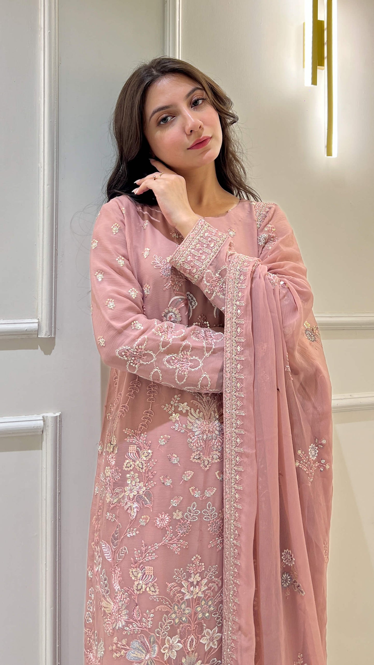 Close-up of floral embroidery on peach shirt and dupatta