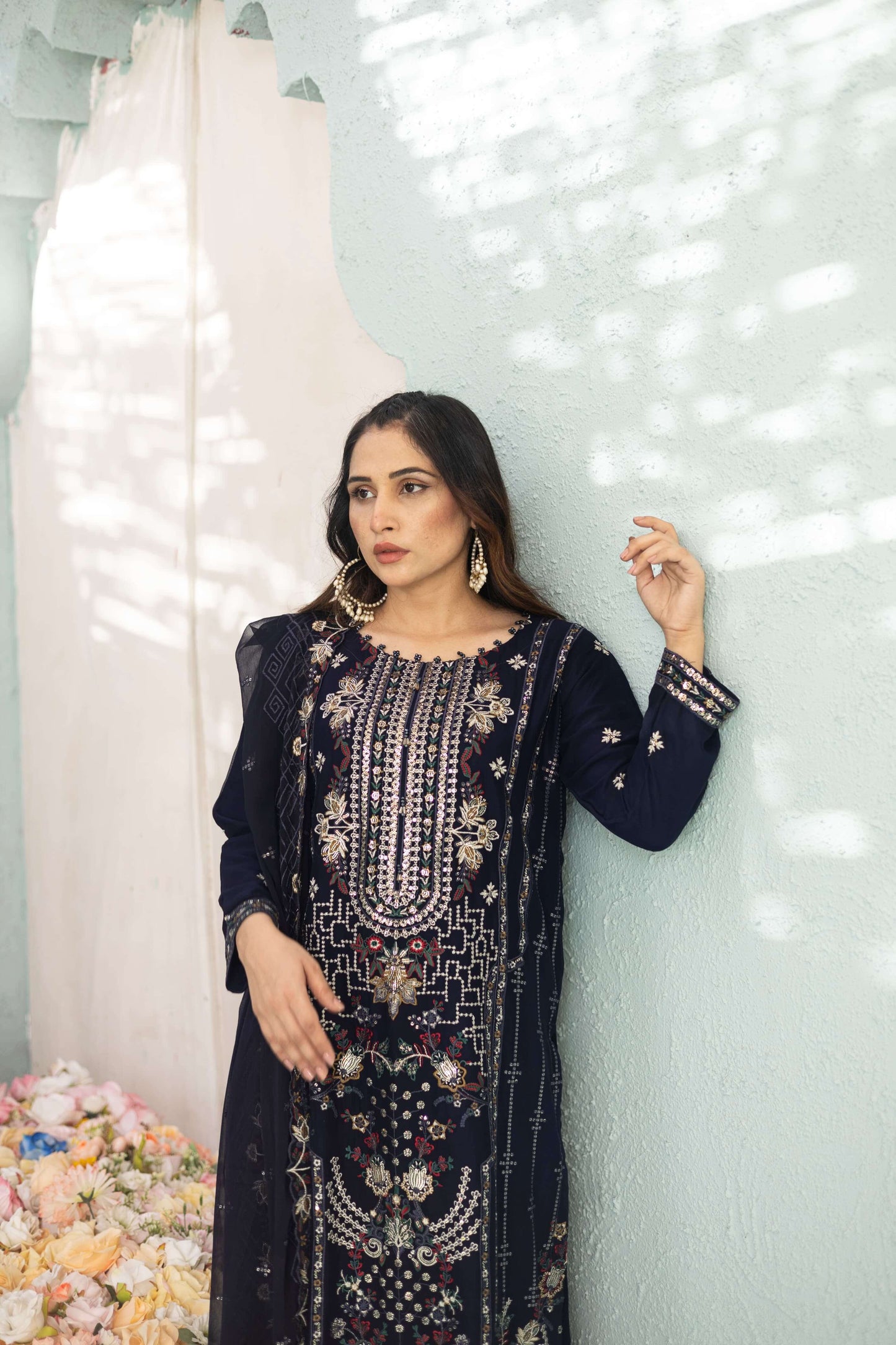 Woman wearing a dark blue chiffon embroidered Shalwar Kameez