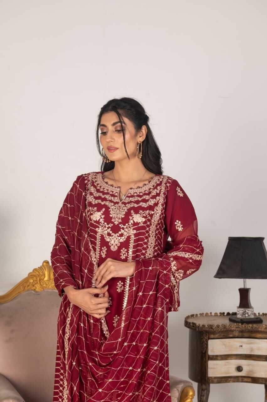 Woman wearing a magenta embroidered chiffon salwar kameez CloseUp