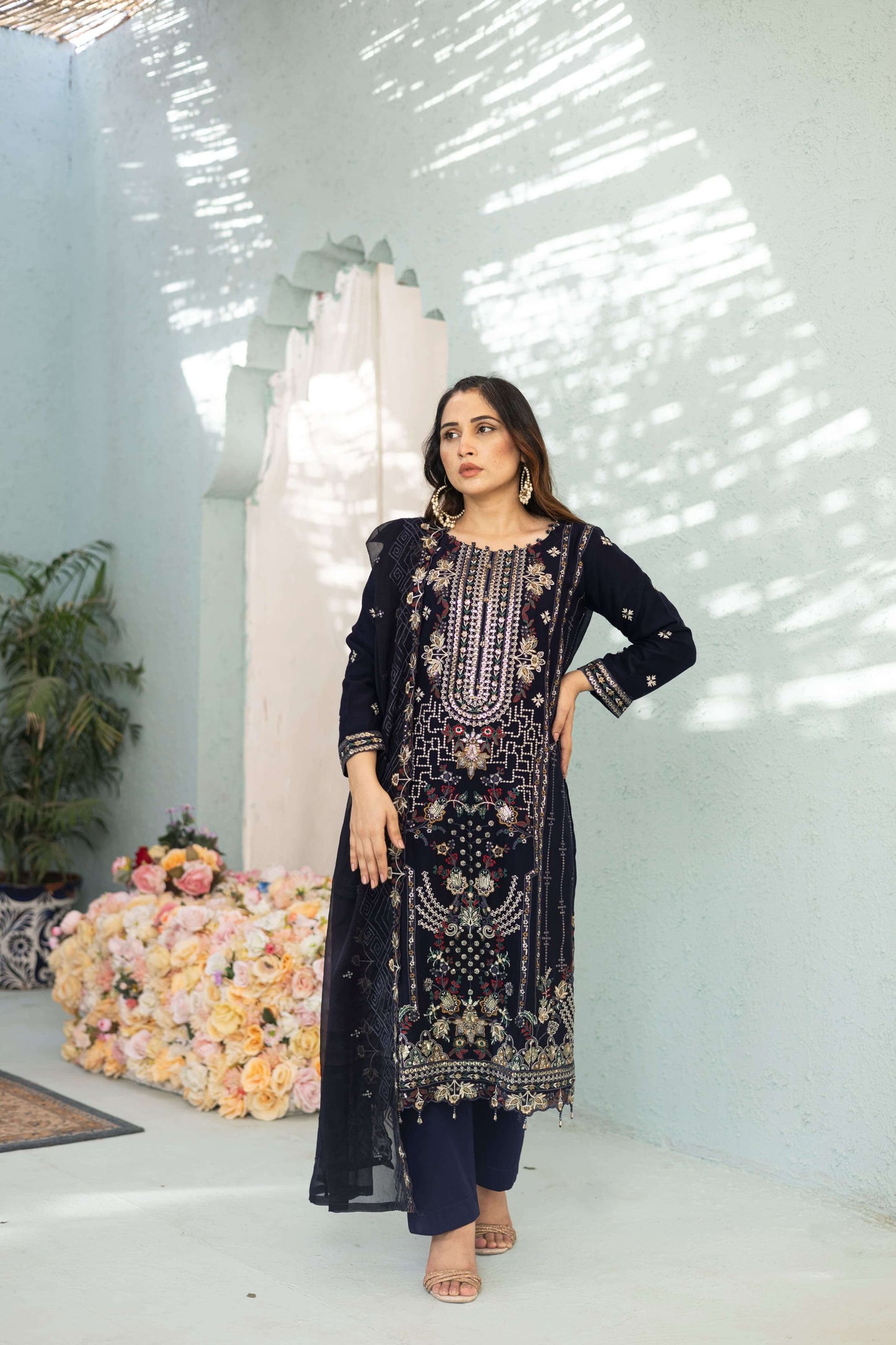 Woman in a dark blue chiffon embroidered dress