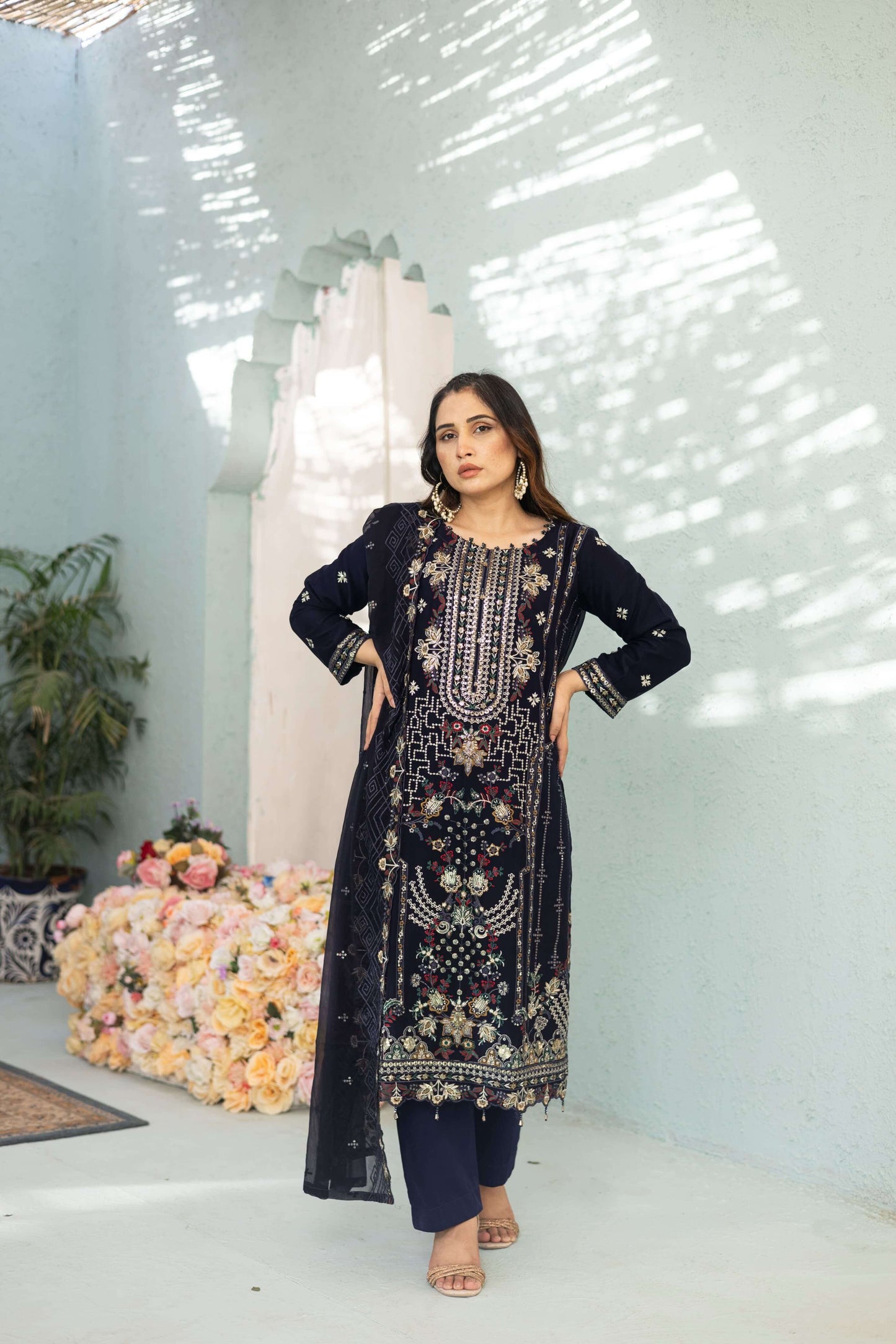Woman wearing a dark blue chiffon embroidered outfit