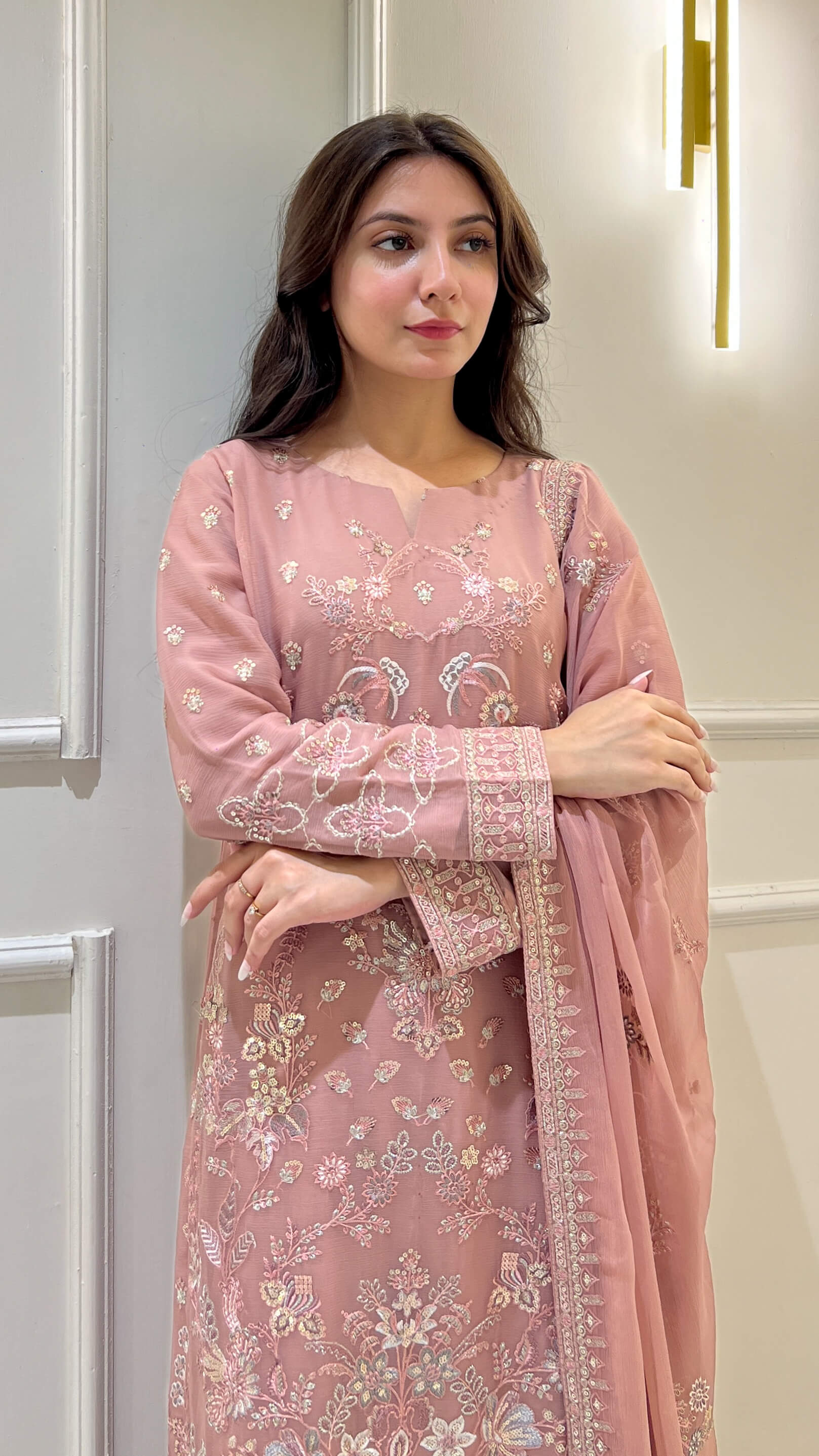 Close-up of floral embroidery on peach  shirt