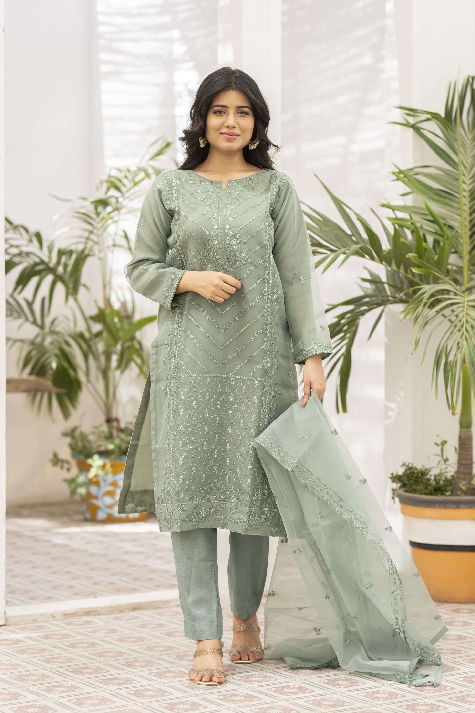 Woman wearing a light green traditional outfit