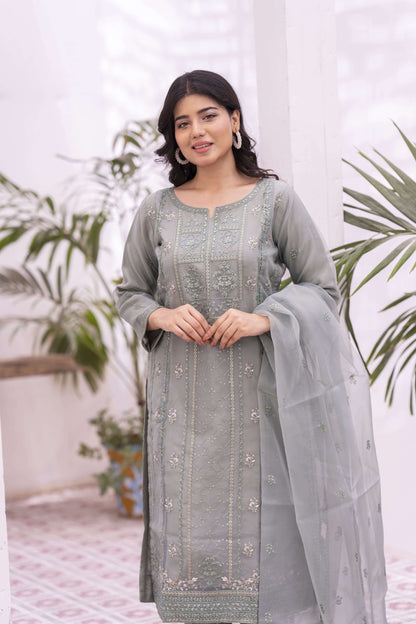 Woman wearing a green embroidered organza outfit with a dupatta