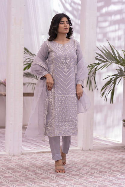 Woman in a lilac embroidered outfit