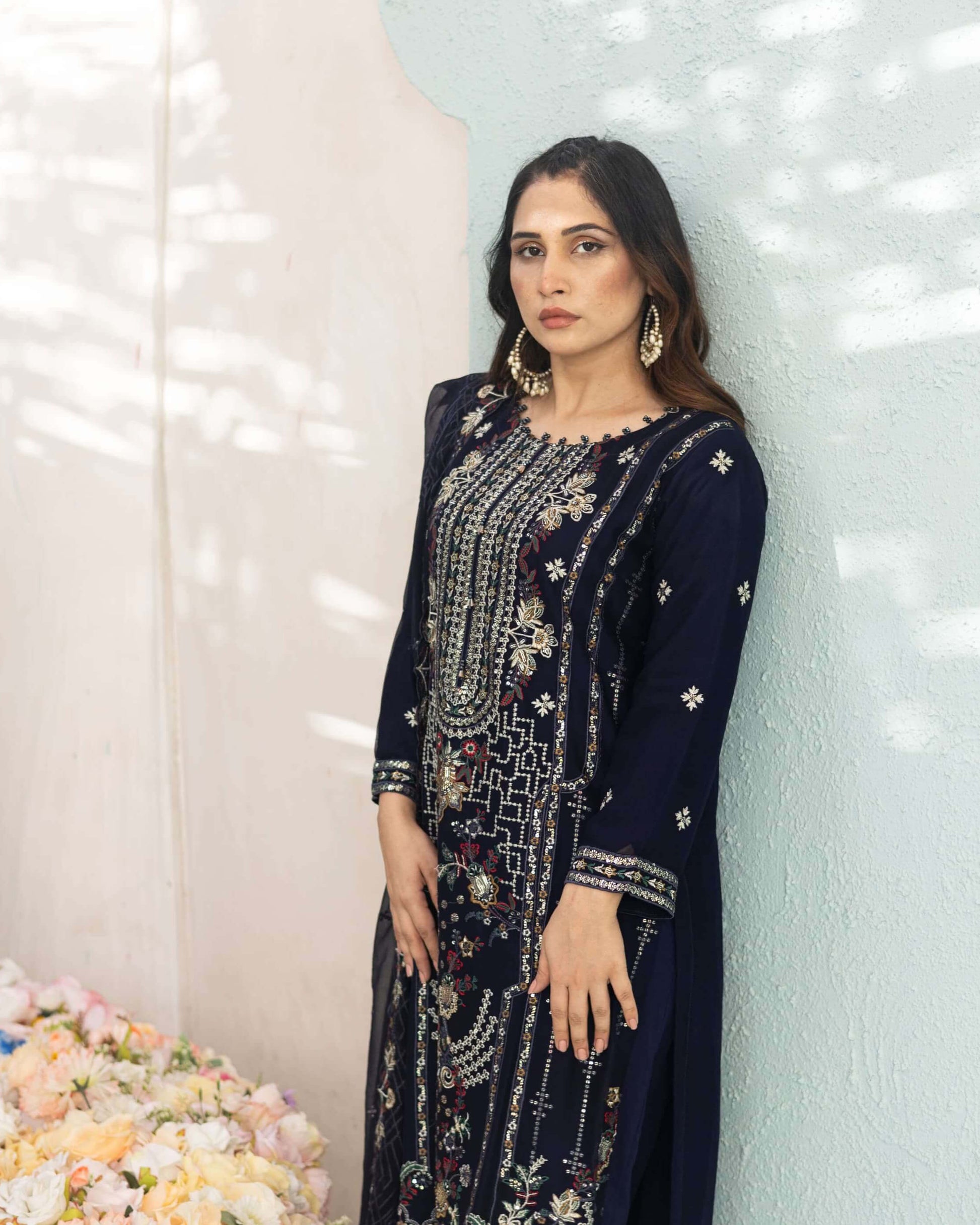 Woman in a navy blue chiffon embroidered salwar kameez